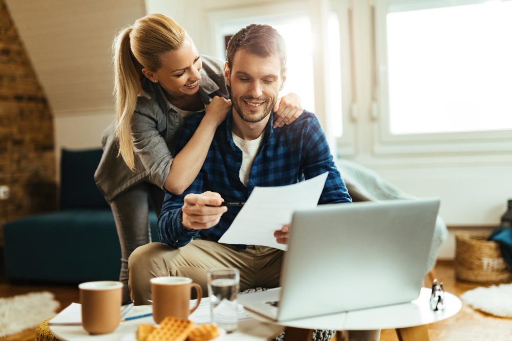 un homme et une femme comparant les rachats de crédits sur ordinateur